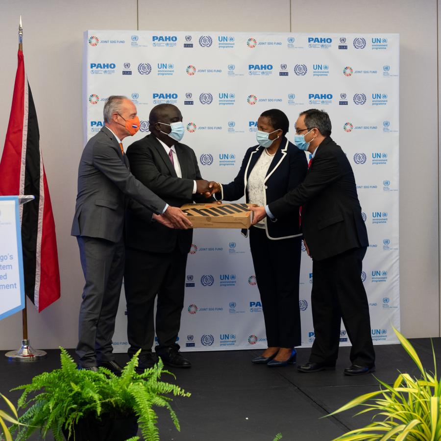 Dutch Ambassador, His Excellency Raphael Varga van Kibèd en Makfalva (far left) and United Nations Resident Coordinator Mr. Dennis Zulu (centre left) ceremonially hands over a device to Minister of Planning and Development, the Honourable Pennelope Beckles (centre right) and Acting Director of Statistics at the CSO, Andre Blanchard (far right)