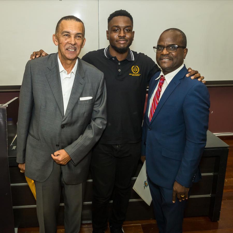 (From left), Former President Anthony Carmona poses with a student and Mr. Eden Charles, Lecturer at the Faculty of Law and Former T&T Permanent Representative to the UN.