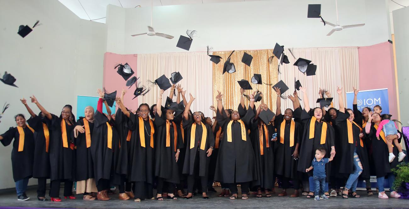 ASMA graduates toss their caps in the air