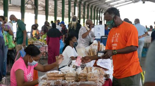 Purchasing bread at the Macoya Market